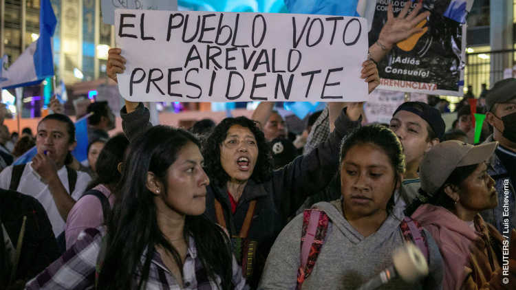 A protester holds a sign that reads “The people vote Arevald president” as supporters of Guatemalan President-elect Bernardo Arevalo protest outside the Supreme Court of Justice (CSJ), Guatemala City, Guatemala 18 September 2023. 