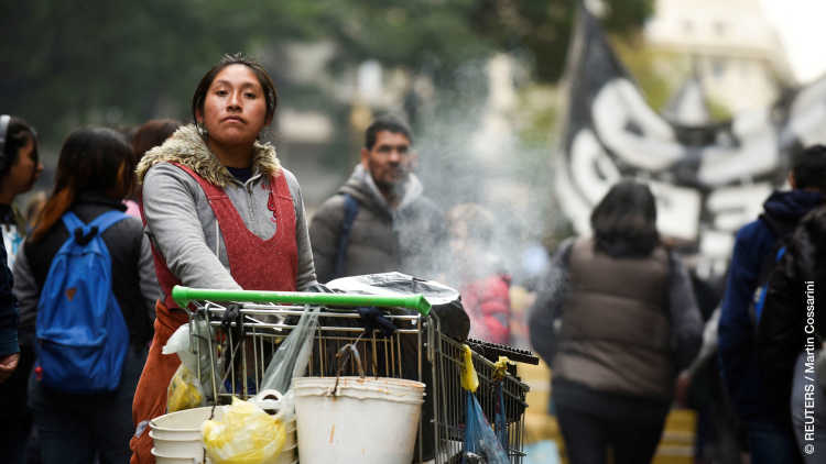 A woman offers food for sale as people march demanding more support from the government at a time of deepening economic crisis ahead of October's general election, in Buenos Aires, Argentina August 24, 2023.