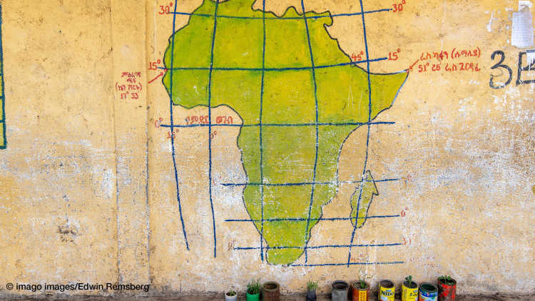 Picture of a hand painted map of Africa on a wall, depicting latitude and longitude