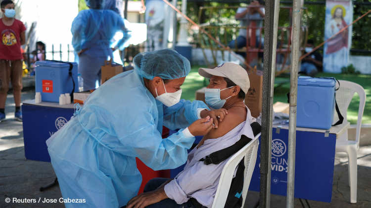 A healthcare worker applies a dose of a coronavirus disease (COVID-19) vaccine at a mobile vaccination center in Panchimalco, El Salvador
