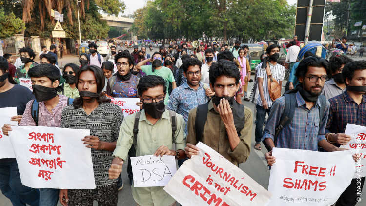 Bangladeshi students from different universities hold placards as they gather in a protest demanding the immediate release of journalist Shamsuzzaman, at Dhaka University Campus, in Dhaka, Bangladesh, March 29, 2023.