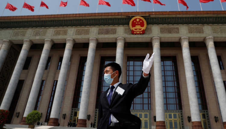 Security member with mask in front of the Great Hall of the people in Beijing