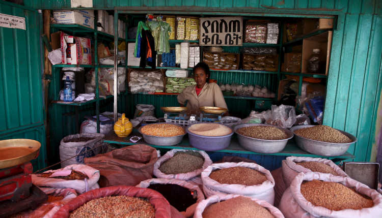 A woman sits in her shop at a market in Ethiopia.