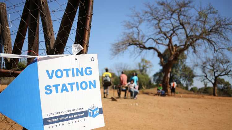 Locals are seen outside a polling station during tense local munincipal elections in Vuwani, South Africa's