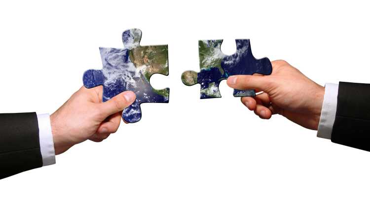 2 hands hold large puzzle pieces
