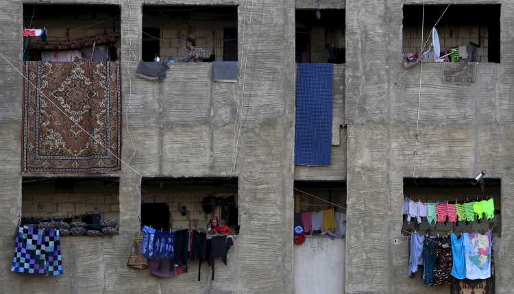 View of a refugee shelter of Syrians in a grey high-rise building in Lebanon.