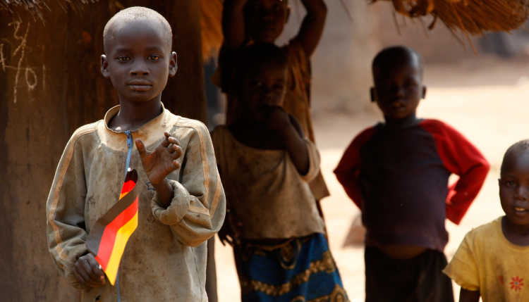 A child holds the German national flag during the visit of German President Horst Koehler at the Coo-Pe refugee camp in Gulu