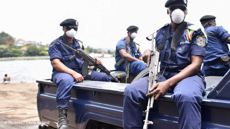 Congolese policemen wear masks as they ride on their patrol pick-up truck amid the coronavirus disease (COVID-19) outbreak in Goma.