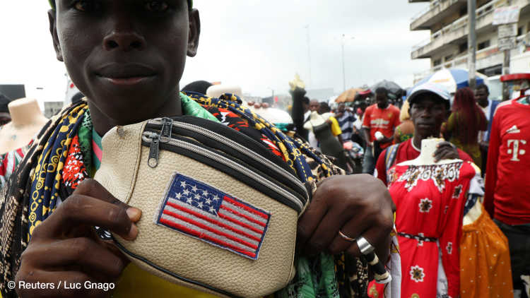A street vendor shows U.S. flag printed on his bag on a street in Abidjan, Ivory Coast