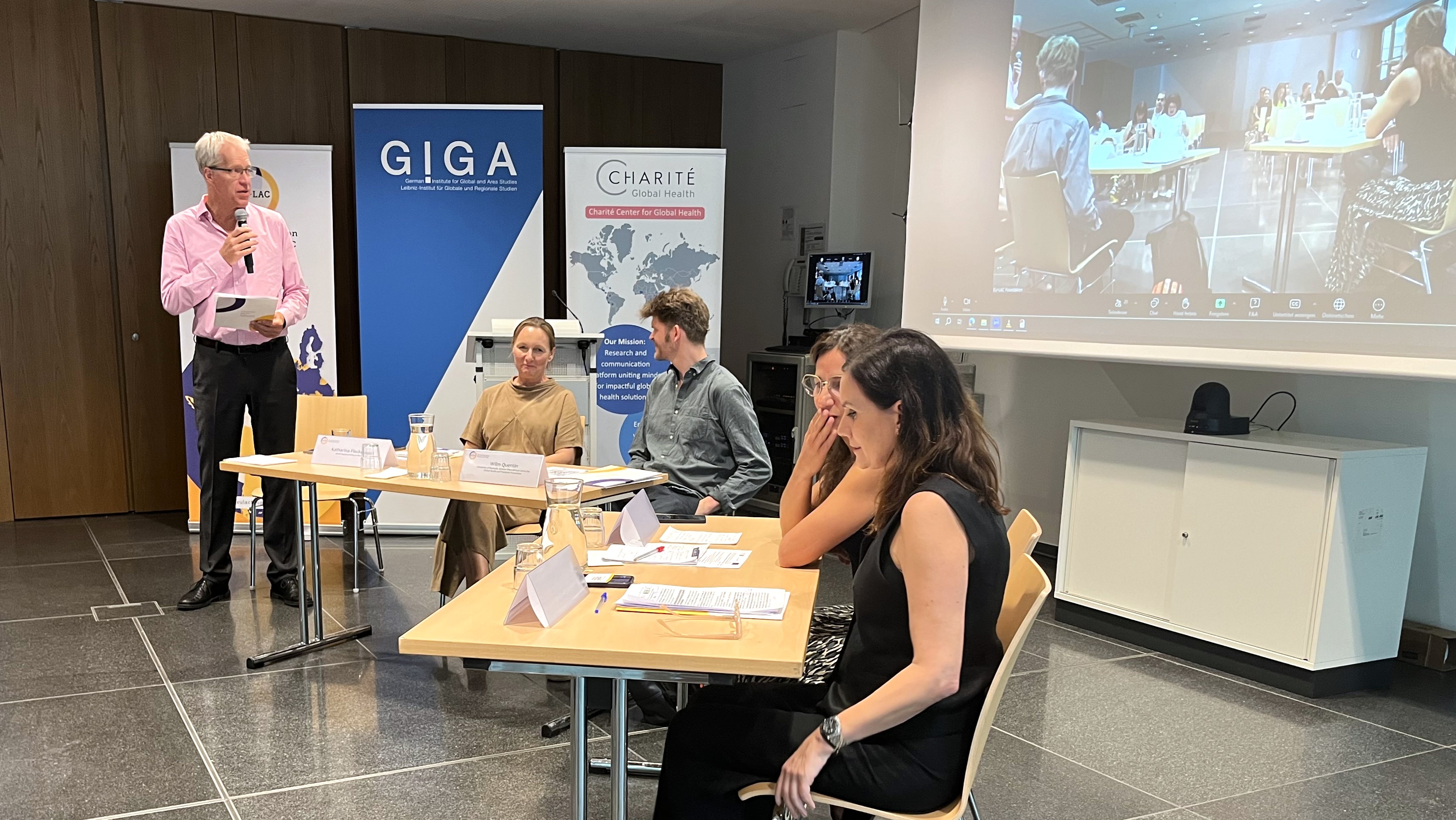 Bert Hoffmann moderates a panel discussion at the symposium