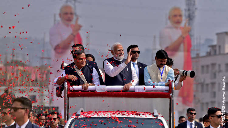 India's Prime Minister Narendra Modi waves to his supporters as he arrives to attend a rally in Guwahati, India, February 4, 2024.