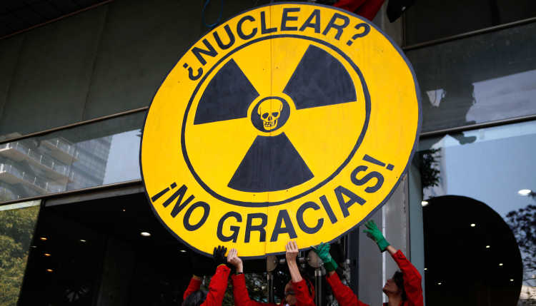 Demonstrators hold up a sign reading "Nuclear Power - No Thanks!".
