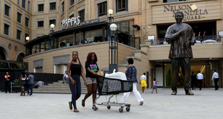 Shoppers push trolleys at an upmarket shopping mall in Sandton, Johannesburg