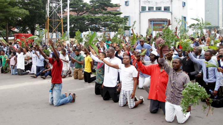 Demonstrators kneel and chant slogans during a protest organised by Catholic activists in Kinshasa, Democratic Republic of Congo