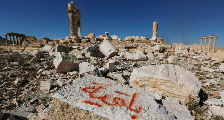 Graffity of the so-called Islamic State on a stone of a destroyed temple.