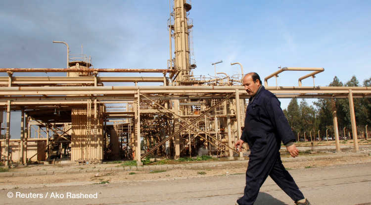 A worker walks past the north gas company on the outskirts of Kirkuk February 2, 2015. Production at an oilfield near Kirkuk remained suspended after incurring severe damage during a weekend attack by Islamic State insurgents, Iraq's oil minister said