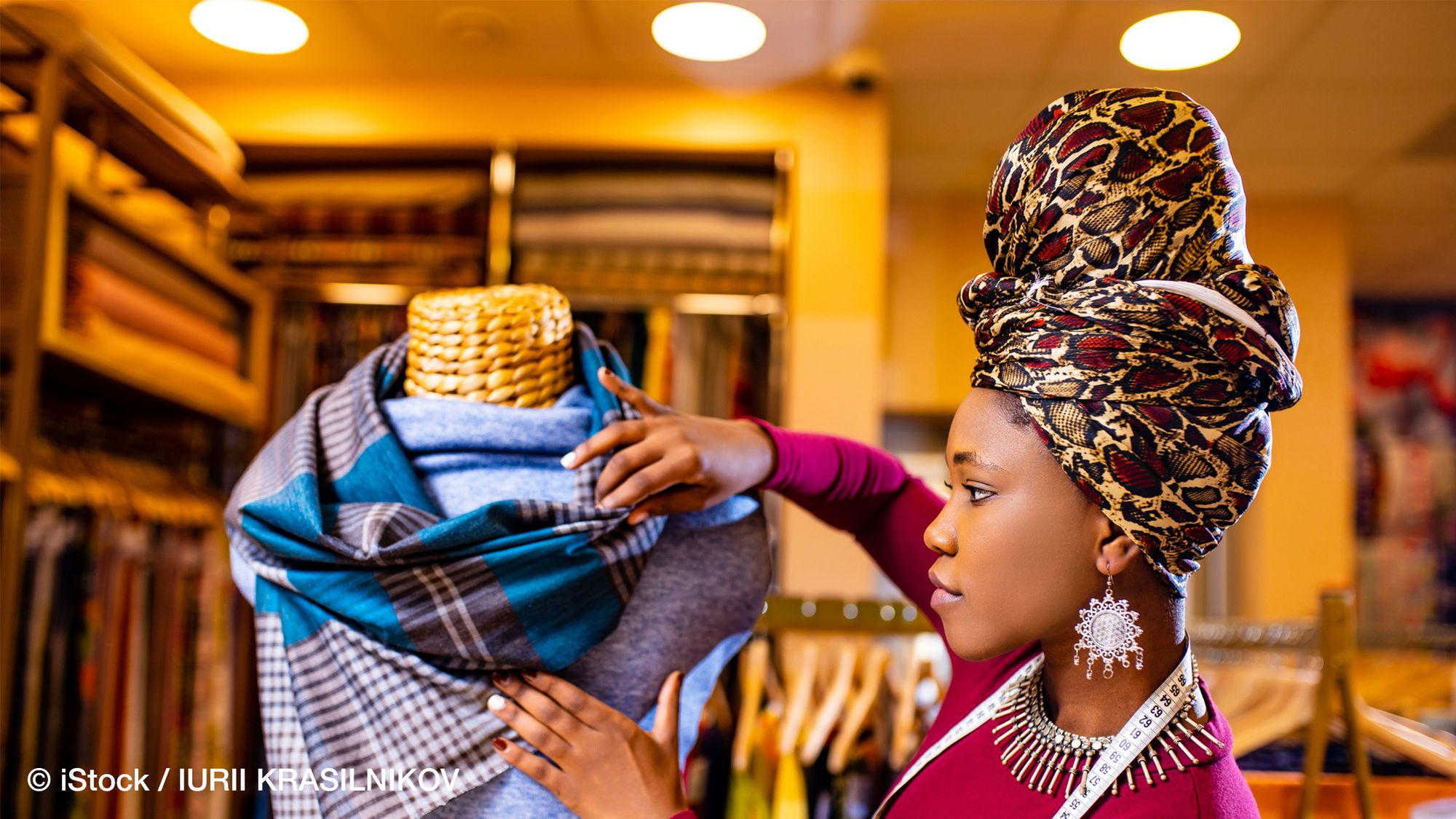 Saleswoman in the warehouse examines fabric