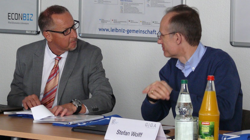 Two members of the conference talk together