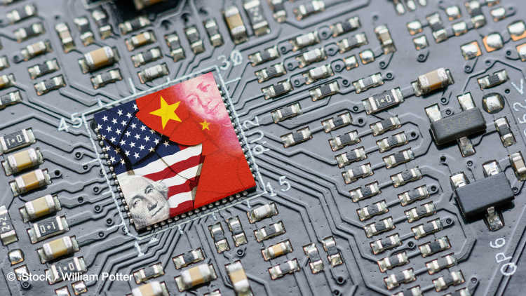 Flag of USA and China on a processor, CPU or GPU microchip on a motherboard. US companies have become the latest collateral damage in the technology war between the US and China. The US limits the sale of AI chips to China.