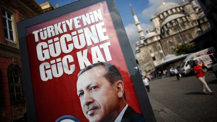 An election poster of Turkey's Prime Minister and presidential candidate Tayyip Erdogan reading "Adds strength to Turkey's power" is seen in Istanbul