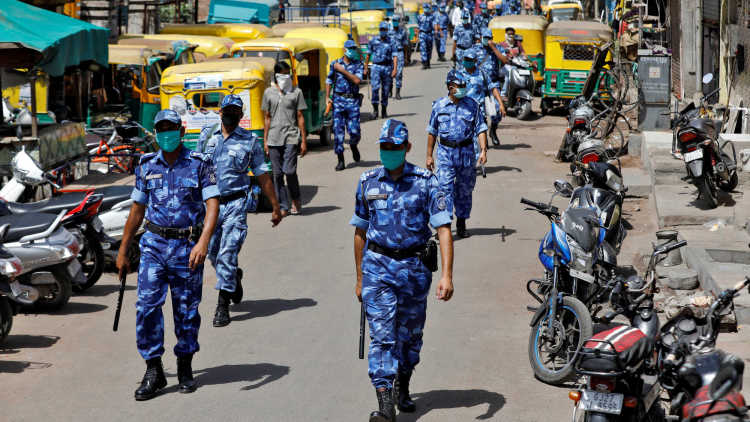 Members of Rapid Action Force (RAF) patrol a neighbourhood to urge people to remain indoors during a 21-day nationwide lockdown to slow the spreading of coronavirus disease (COVID-19), in India
