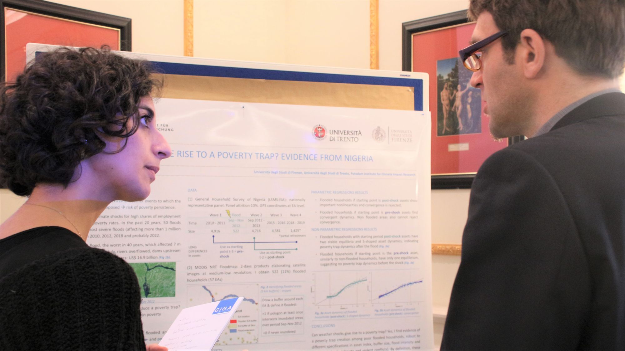 Participants of Leibniz Environment and Development Symposium 2022 chat during poster session in conference room at Baseler Hof, Hamburg.