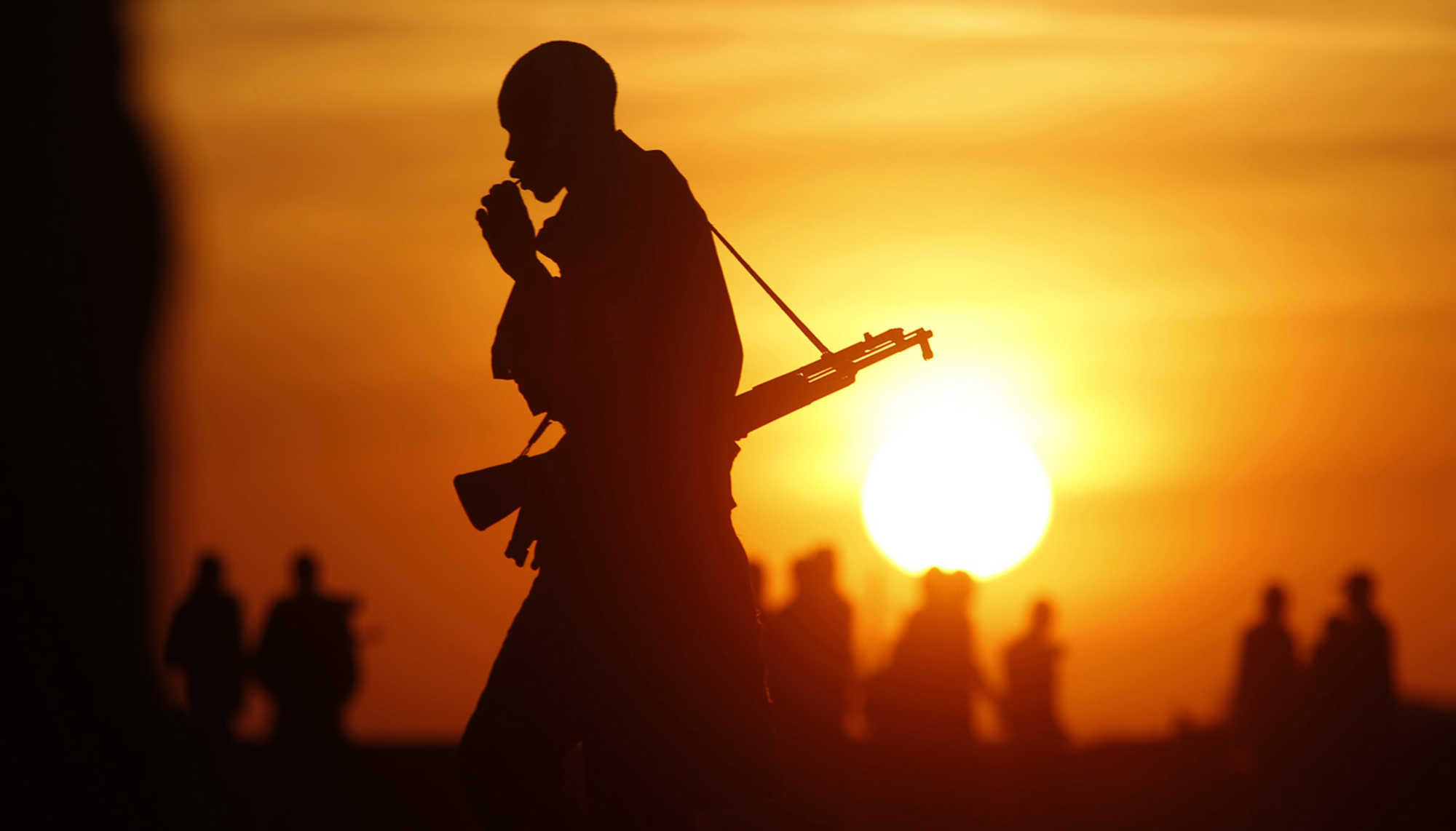 Rebel fighters walk in a rebel controlled territory in Upper Nile State.
