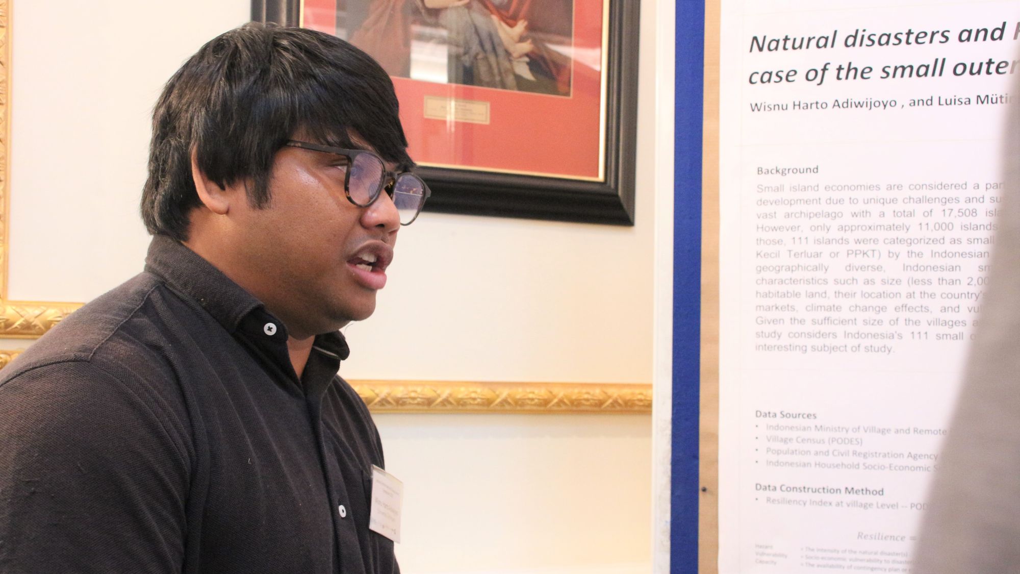 Participants of Leibniz Environment and Development Symposium 2022 chat during poster session in conference room at Baseler Hof, Hamburg.