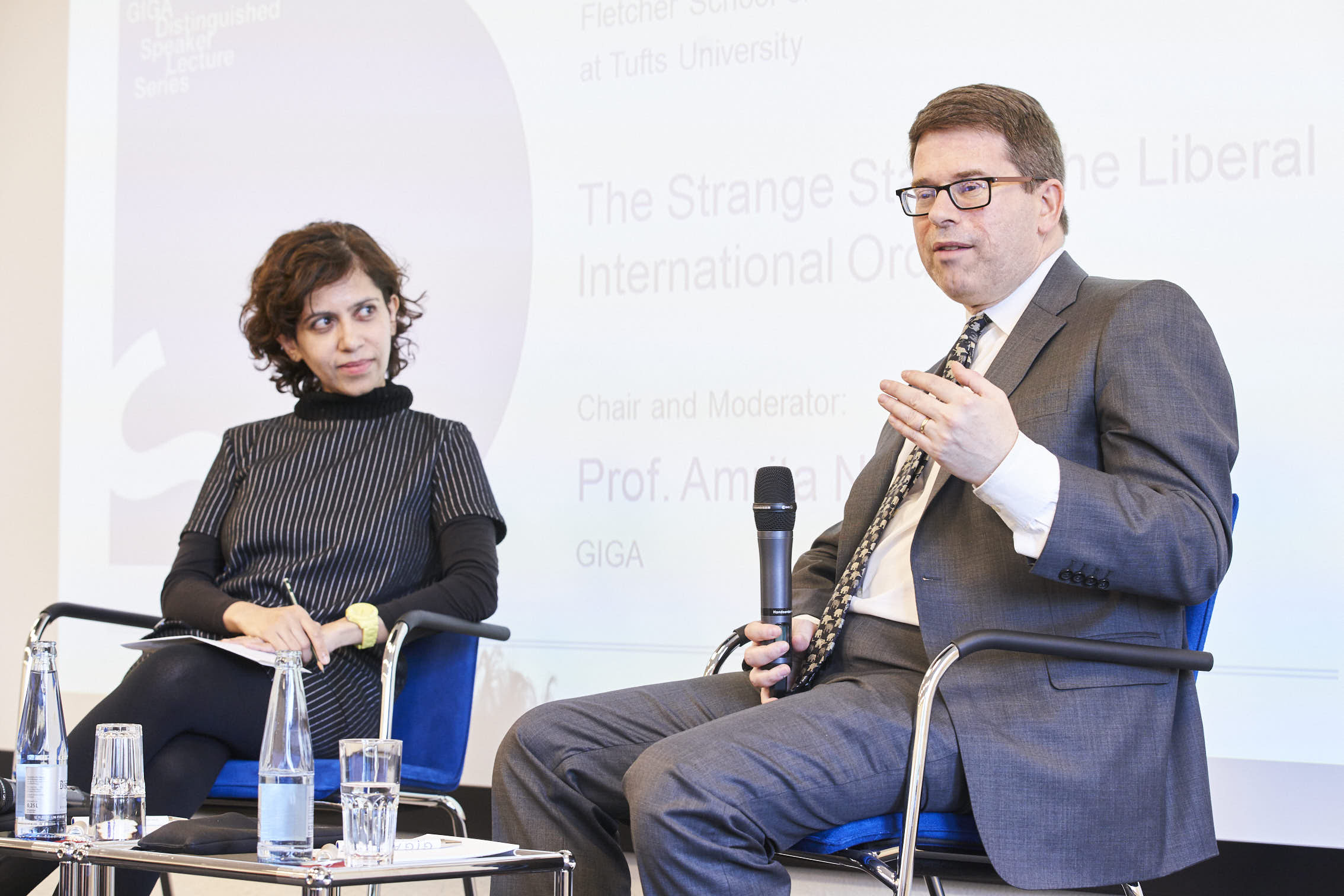 Picture of Professor Amrita Narlikar and Professor Daniel Drezner on podium