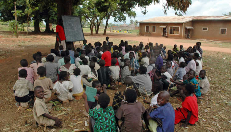 Pupils of the Kinji Primary School in Sudan during a lesson under a tree.
