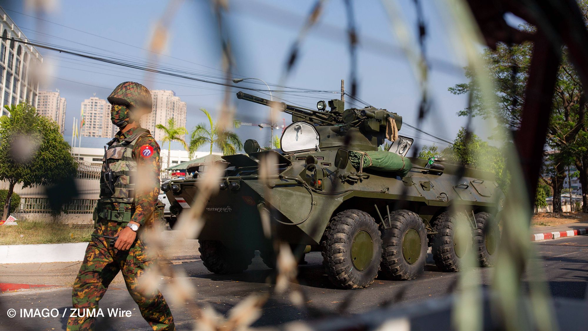 A soldier patrols the street in front of the Central Bank building