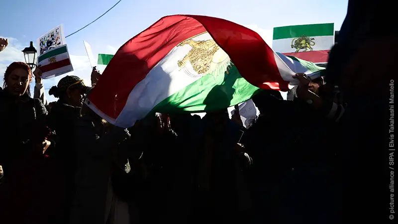 Sunlight illuminates a pro-Shah Iranian flag during a demonstration at Syntagma Square in Athens, Greece, on January 11, 2026.