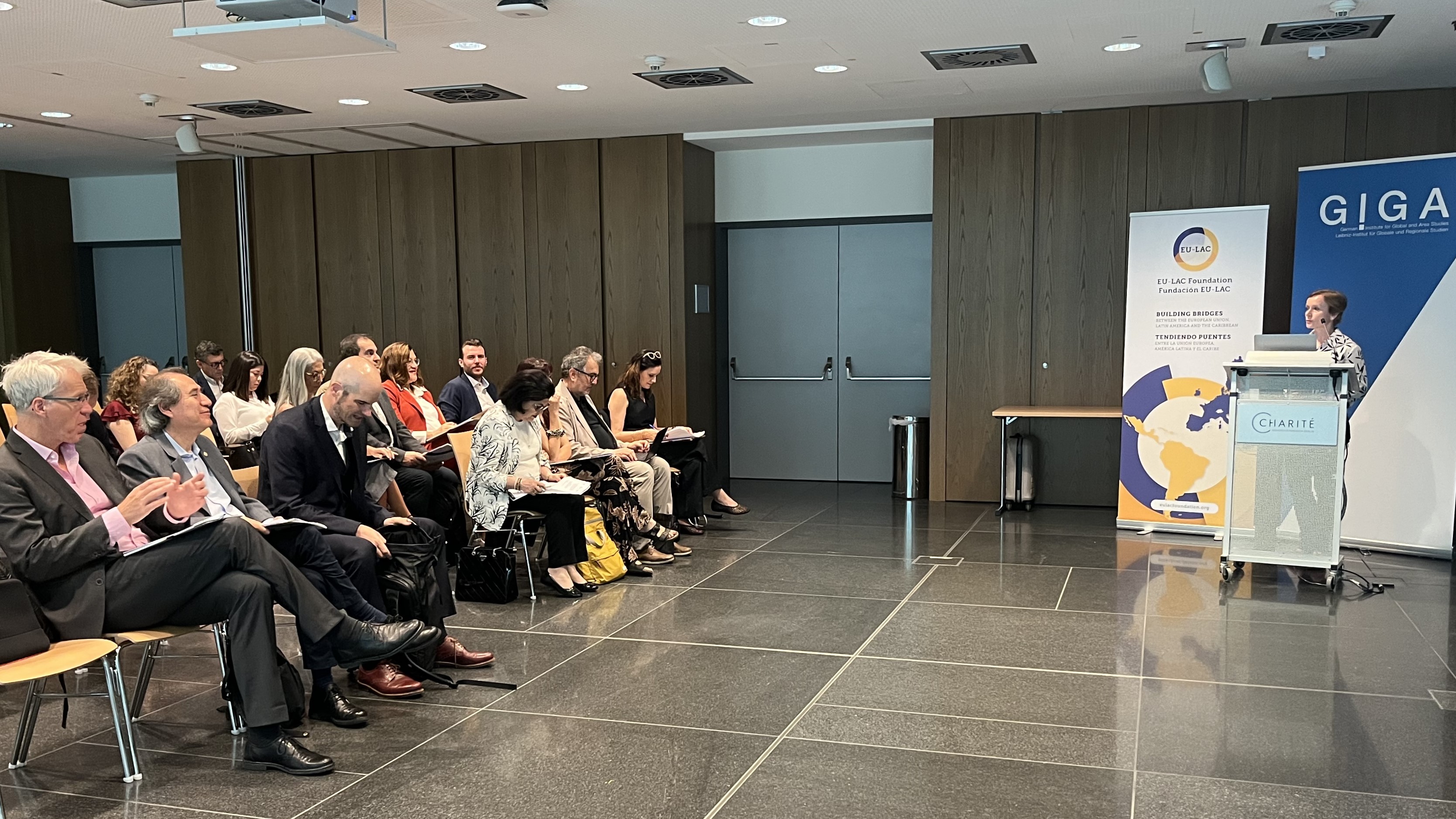 Anna Barrera, moderator, speaking at the symposium
