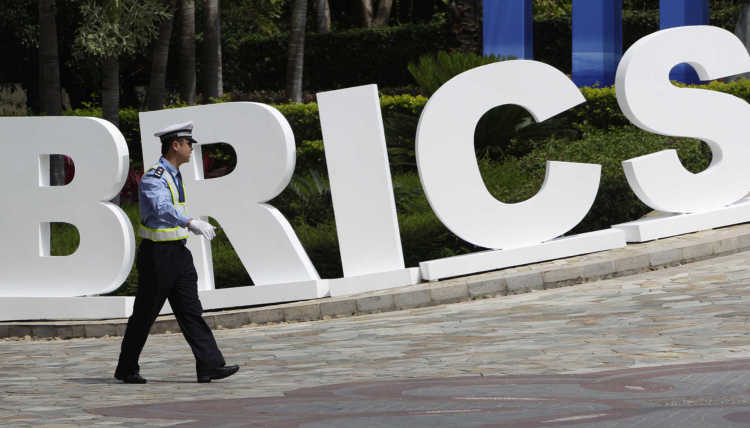 Police in front of a BRICS sign