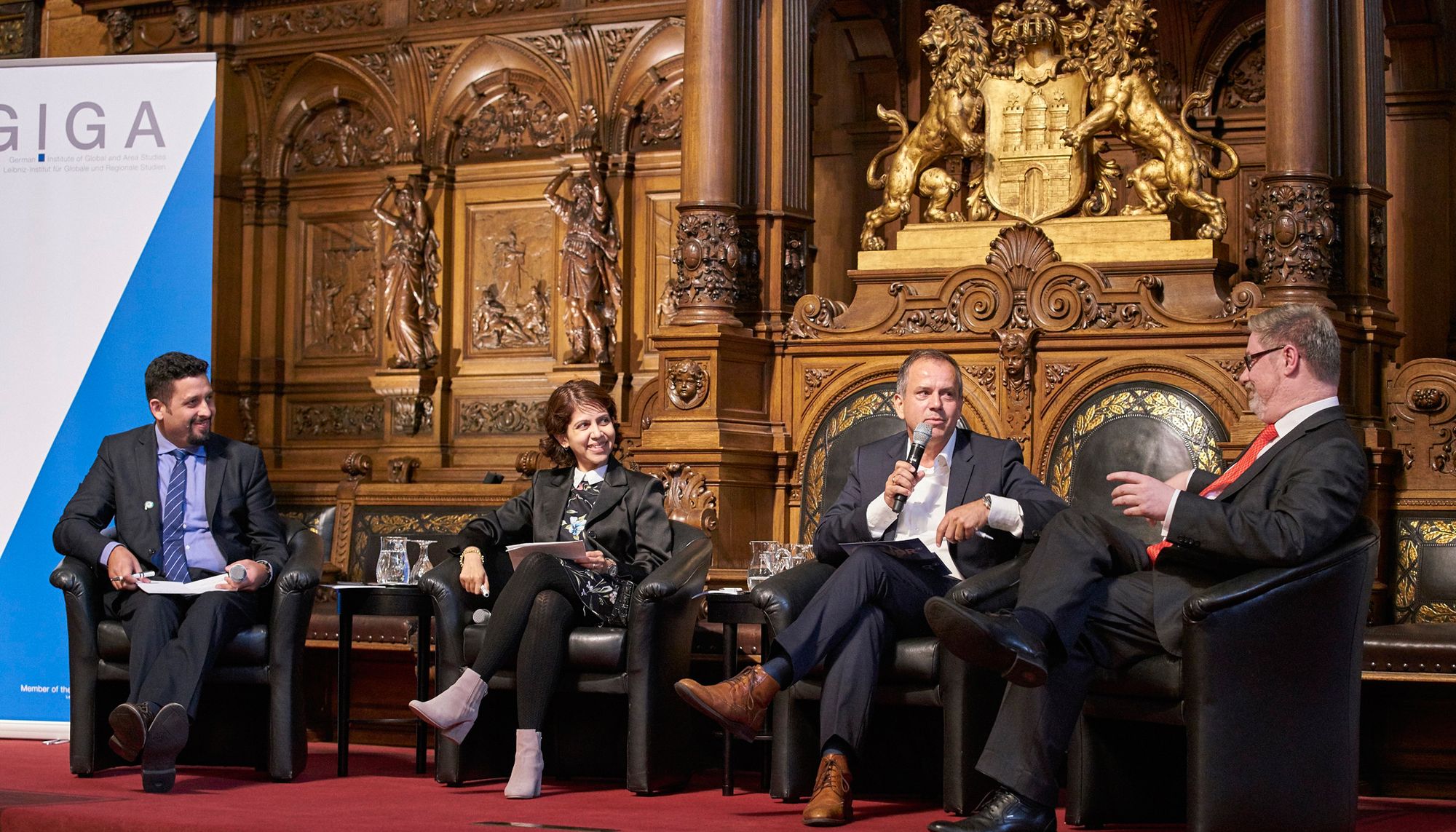 Podium from left: Wael Hmaidan, Professor Amrita Narlikar, Andreas Cichowicz, Professor Lars Hendrik Röller