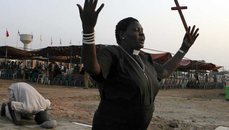 A woman prays before the Independence Day celebrations in South Sudan's capital Juba.
