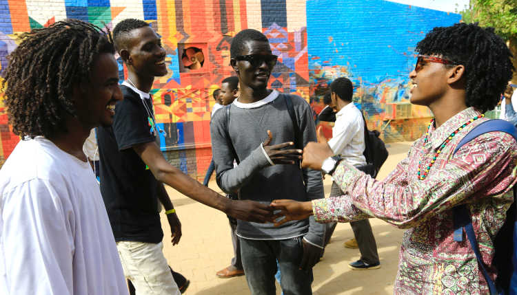 Students in Sudan greet each other.